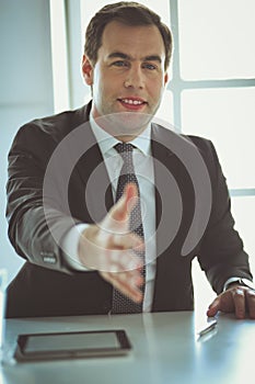 Portrait of businessman giving hand for handshake