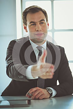 Portrait of businessman giving hand for handshake