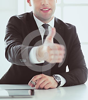 Portrait of businessman giving hand for handshake.