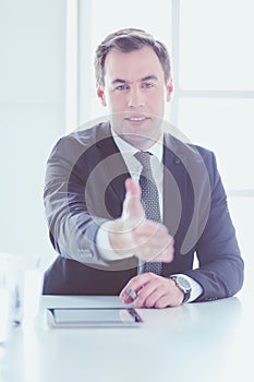 Portrait of businessman giving hand for handshake.