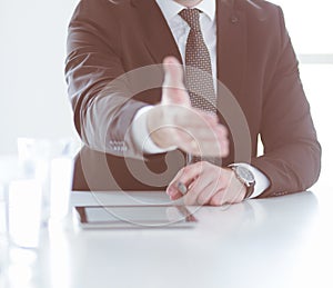 Portrait of businessman giving hand for handshake.