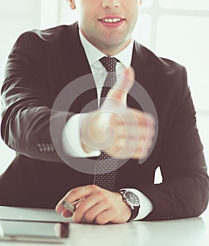 Portrait of businessman giving hand for handshake.