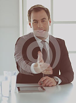 Portrait of businessman giving hand for handshake.