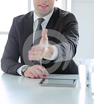 Portrait of businessman giving hand for handshake.