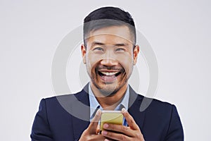 Portrait, businessman and happy with phone in studio for, social media, networking and smile. Asian male person