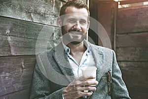 portrait of businessman having break holding coffee