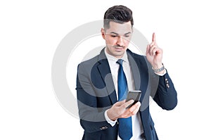 Portrait of businessman having an idea and pointing finger up