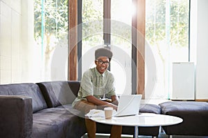 Portrait Of Businessman Having Working Lunch In Office