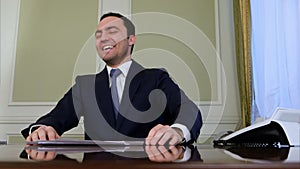 Portrait of businessman laughing hysterically
