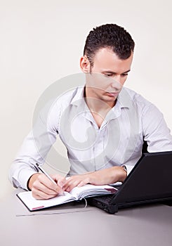 Portrait of businessman making notes