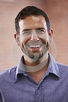 Portrait Of Businessman In Office Standing By Window