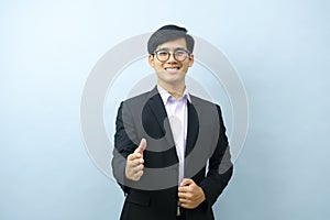 Portrait of businessman pointing at camera.