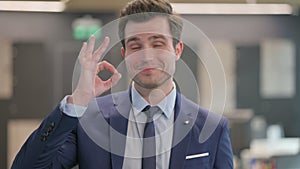 Portrait of Businessman showing Ok Sign with Finger