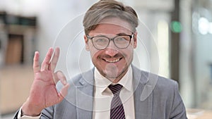 Portrait of Businessman showing Ok Sign with Hand