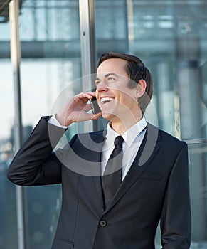 Portrait of a businessman talking and laughing on mobile phone