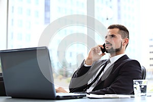 Portrait of businessman talking on mobile phone