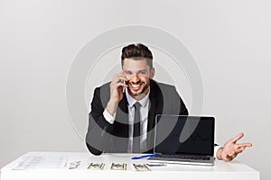 Portrait of businessman talking on mobile phone in office