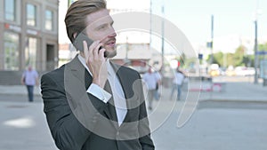 Portrait of Businessman Talking on Phone Outdoor