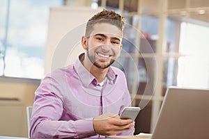 Portrait of businessman using smart phone