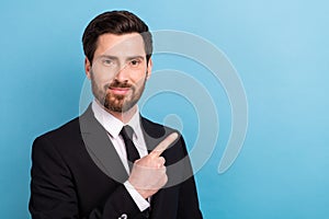 Portrait of businessman wear stylish jacket necktie pointing finger empty space discount his services isolated on blue