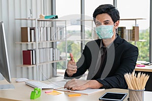 Portrait of businessman wearing medical mask during working in office to protect from coronavirus covid 19 infection, coronavirus