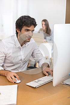 Portrait of businessman working on computer in office