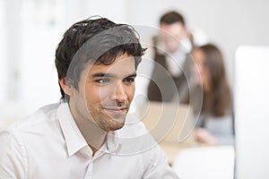 Portrait of businessman working on computer in office