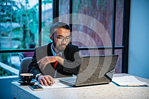 portrait of businessman working late at his office