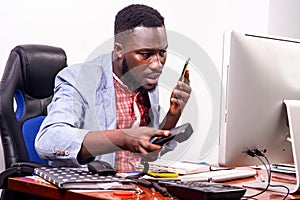 Portrait of a businessman working with telephone and computer