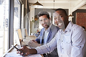 Portrait Of Businessmen Meeting In Coffee Shop