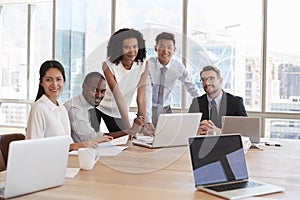 Portrait Of Businesspeople Meeting Around Table In Office