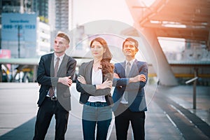 Portrait of businessteam pointing up the future on blurred city background. Business success concept