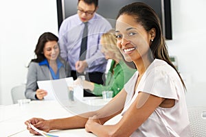 Portrait Of Businesswoman In Boardroom With Colleagues