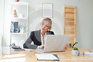 Portrait of businesswoman doubting and planning in her workplace