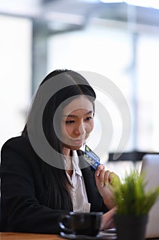 Businesswoman holding credit card enjoy shopping online or making online payment with computer laptop.