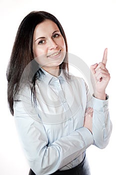 Portrait of businesswoman pointing upwards.