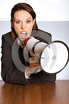 Portrait of businesswoman shouting through megaphone
