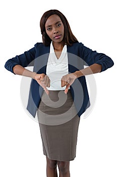 Portrait of businesswoman showing thumbs down