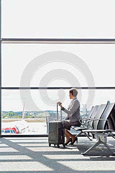 Portrait of businesswoman sititng while waiting for boarding in airport