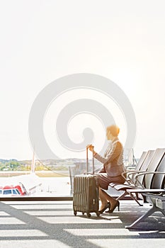 Portrait of businesswoman sititng while waiting for boarding in airport