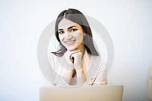 Portrait of businesswoman sitting in front of laptop and smile