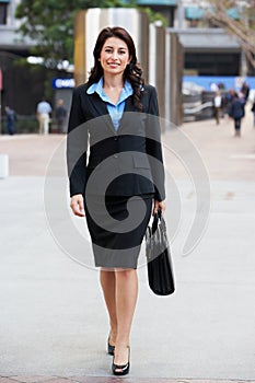 Portrait Of Businesswoman Walking Along Street