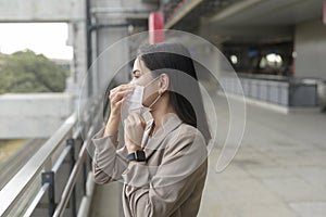 Portrait of  Businesswoman is wearing face mask work in modern City , people lifestyle , working under Covid-19 pandemic concept