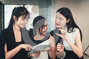 Portrait of Businesswomen Enjoying Shopping Online in Office Workplace, Asian Women Discussing Something About Credit Card While