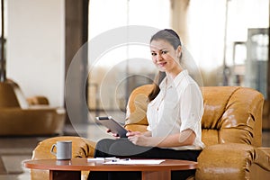 Portrait of busy business woman working and sitting at sofa