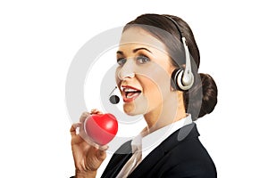 Portrait of call center woman holding heart model