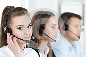 Portrait of call center worker accompanied by her team