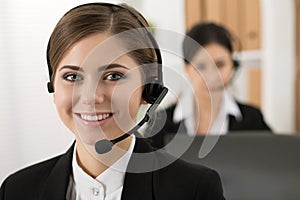 Portrait of call center worker accompanied by her team