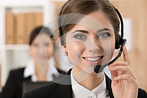 Portrait of call center worker accompanied by her team