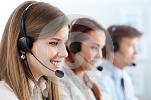 Portrait of call center worker accompanied by her team